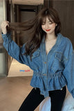 Woman wearing a blue denim jacket in an indoor setting