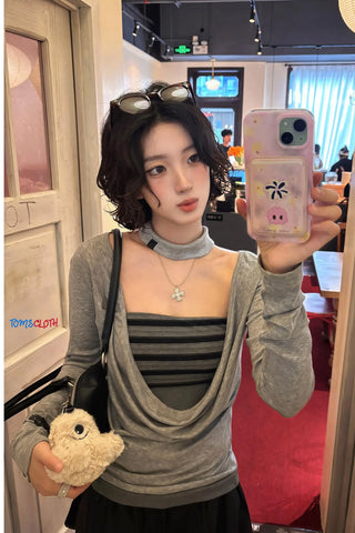 Person taking a mirror selfie in a casual setting with a phone case featuring cartoon characters.