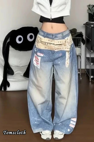 Person wearing oversized blue jeans with a patterned bandana, standing in a room.