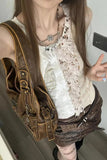 Person wearing a steampunk-style outfit with leather vest and lace top.