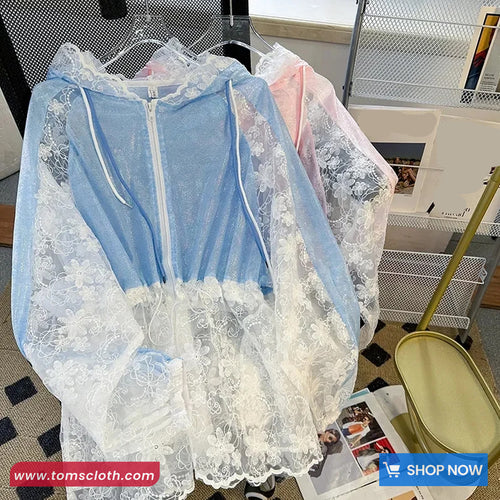 Light blue lace dress on a hanger with a blurred indoor background