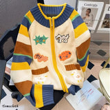 Colorful striped sweater with cartoon designs on a chair