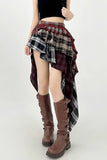Person wearing a plaid skirt and brown boots on a white background