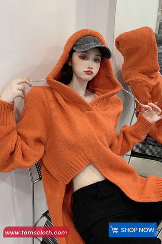 Person wearing an orange hoodie with a plain background