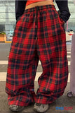 Red plaid pants worn by a person on a street.