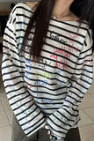 Person wearing a striped sweater with colorful text