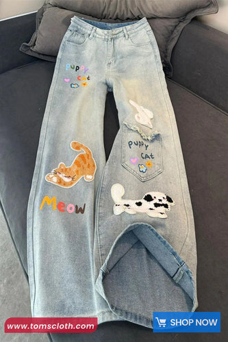 Denim jeans with various patches on a gray couch