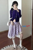 Person wearing a purple top and polka dot skirt taking a mirror selfie.
