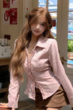 Woman wearing a pink striped shirt in a casual indoor setting