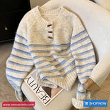 Beige and blue striped sweater on a chair with 'TomsCloth' branding.