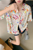 Person wearing a colorful patterned shirt with a neutral background