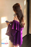 Woman wearing a purple dress with a blurred background