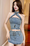 Woman wearing a denim outfit with a high neckline and belt in an indoor setting.