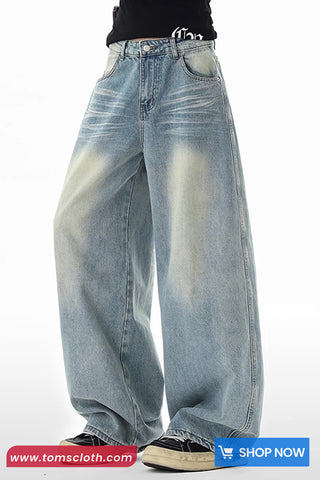 Worn blue jeans on a white background with 'tomscloth.com' branding.