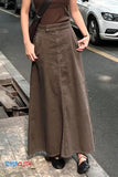 Person wearing a brown long skirt on a street.