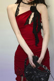 Red dress with black lace details worn by a model against a plain background