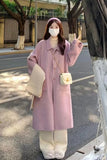 Person wearing a pink coat and white pants on a street.