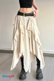 Person wearing a layered beige skirt with a black belt and black boots on a plain background.
