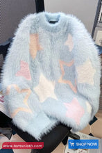 Fluffy blue sweater with star patterns on a chair