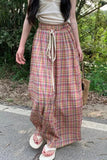 Person wearing plaid pants with a natural background