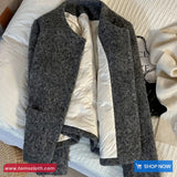 Gray coat with white lining on a bed, brand 'Toms Cloth' visible