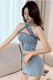 Woman wearing a denim dress with a halter neck design in a living room setting.