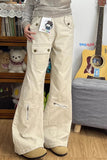 Person wearing beige cargo pants with a guitar and stuffed toys in the background