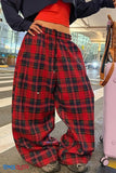 Person wearing red plaid pants with a blurred background