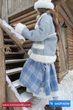 Person in a blue coat with white fur trim walking up snowy stairs.