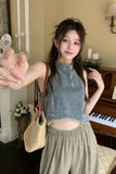 Woman taking a selfie in a room with a piano and decorative items.
