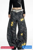 Black camouflage pants with yellow stars worn by a person on a white background