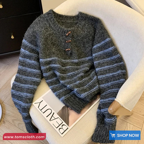 Striped sweater on a chair with a visible brand tag and website URL.