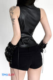 Person wearing a black leather top and shorts with lace-up gloves on a white background