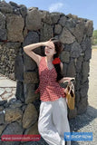 Woman posing against a stone wall with a 'Shop Now' banner at the bottom.