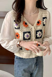 Person wearing a crochet vest with floral patterns holding a bowl.