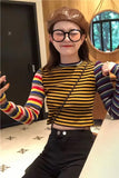 Person wearing a striped shirt and brown hat indoors