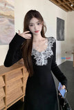 Woman in a black dress with white lace details in an indoor setting