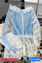 Light blue lace dress with a zipper on a hanger against a blurred background.