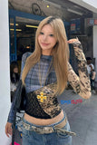 Woman posing outdoors with a brand logo in the corner