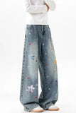 Blue jeans with star patterns worn by a person on a white background