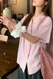 Woman holding a white lace item in a casual indoor setting