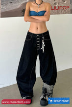 Person wearing a blue strapless top and black high-waisted jeans with fur-trimmed shoes on a plain background.