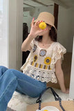 Person wearing a decorative top and straw hat, holding a lemon in front of a mirror.