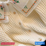 Close-up of a textured fabric with floral embroidery and buttons, featuring a 'Shop Now' button at the bottom.