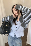Person wearing a gray and white striped cardigan with a black quilted backpack indoors.