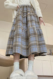 Person wearing a plaid skirt in an indoor setting