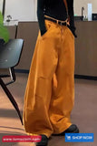 Person wearing mustard yellow pants in an indoor setting