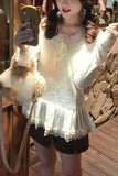 Person wearing a white lace top and black shorts, holding a phone with a bear case.