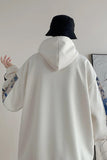 Person wearing a white hooded jacket with a plain background