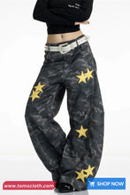 Camouflage pants with yellow stars and a black top on a white background